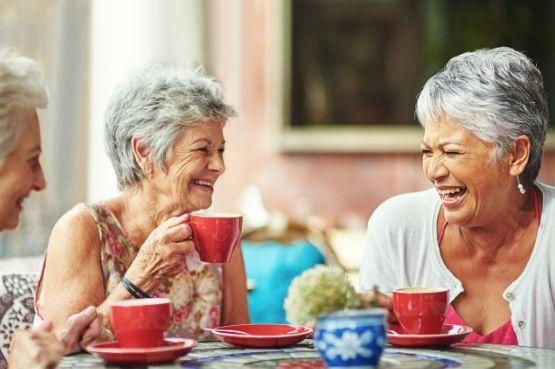 three people laughing over lunch