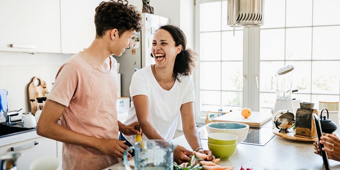 two people cooking at home