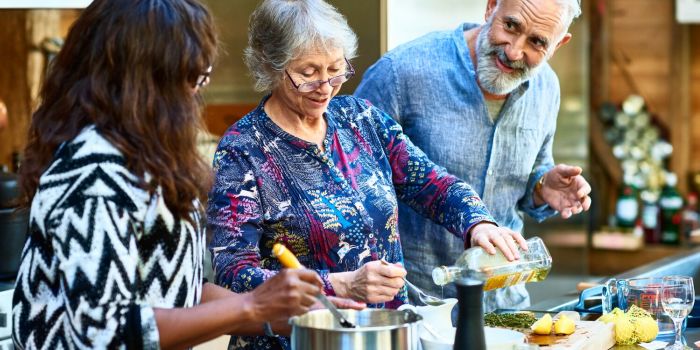 three older people cooking together