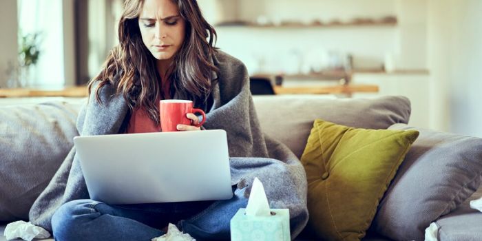 person with working on sofa, fighting a cold