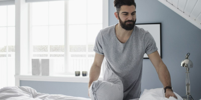 an adult changing bedsheets