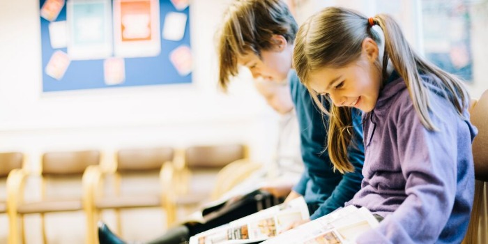 children reading books in a waiting room