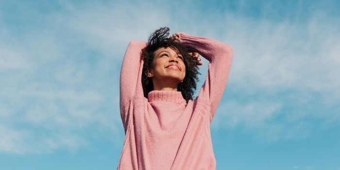 person looking up at the sky and smiling
