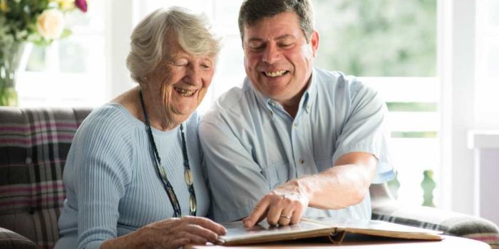 two seniors in a care home looking at photographs