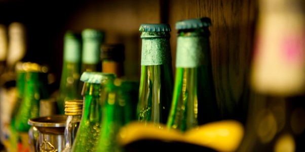row of green bottles with tops