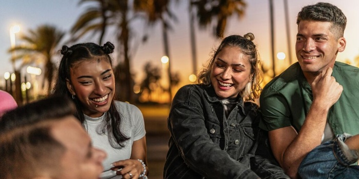 group of friends talking and laughing outdoors