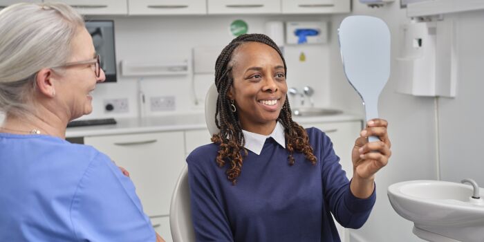 client checks teeth in mirror