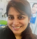 Rabia Ahmed is a dental hygienist and in the photo is smiling in her uniform 