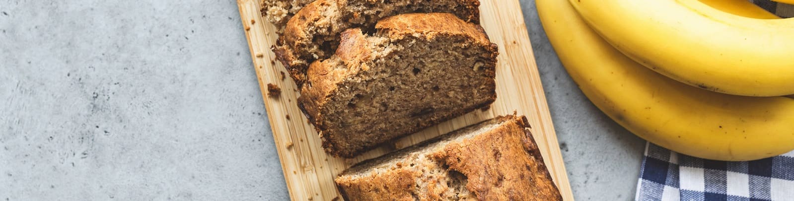 bananas and baked banana bread on concrete surface