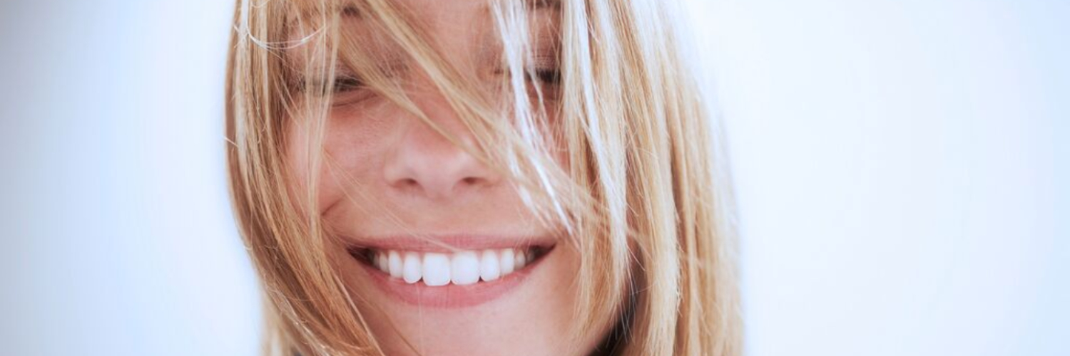 A smiling women with her eyes closed.