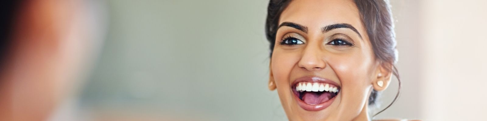 Young woman smiling in mirror