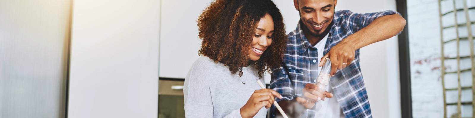 Happy man and woman cooking healthy recipe